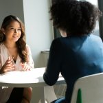 A coach and client in a focused one-on-one conversation