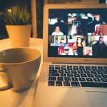 A laptop screen showing a woman on a video call during an online coaching session - the kind of conversation an AI notetaker records and summarizes.