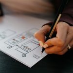 A coach planning a coaching business on paper.
