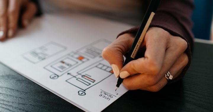 A coach planning a coaching business on paper.