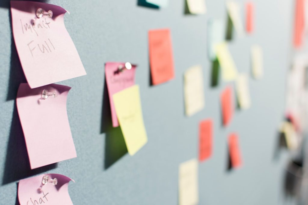 Colorful sticky notes pinned in rows across a board, the way a service business maps out every step of a client workflow before deciding what to automate.
