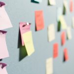 Colorful sticky notes pinned in rows across a board, the way a service business maps out every step of a client workflow before deciding what to automate.
